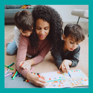 Mother with two children colouring