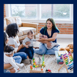 Mothers sat with their children at a support group